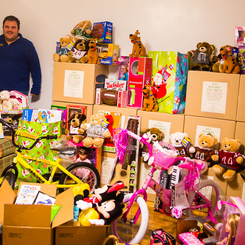 Anna and Philip Frattaroli taking a break from boxing up the toys for the 2013 Holiday Toy Drive to benefit the Italian Home for Children in memory of Mark Frattaroli.